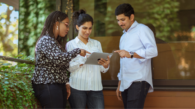 A diverse group of three Esri employees gather to have a conversation at Esri Headquarters in Redlands, California.