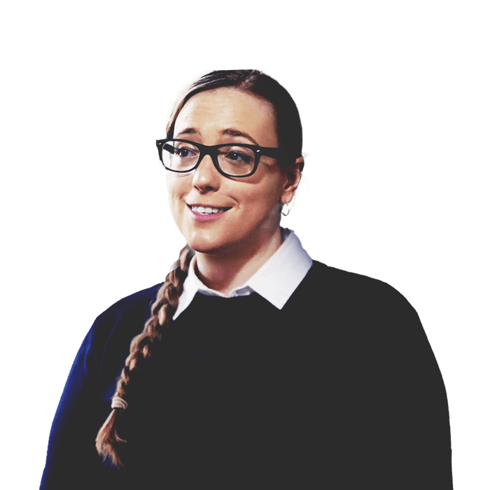 Molly Burhans, GIS advisor to the Vatican, wearing a sweater and glasses in front of sand dunes