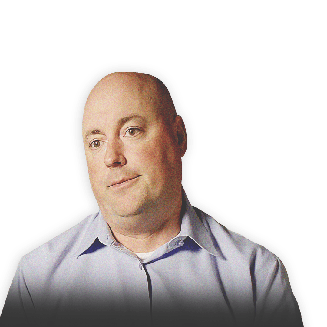 John Morrison, part of the Urban Search and Rescue team for the United States Agency for International development (USAID), in front of a background of buildings damaged in an earthquake