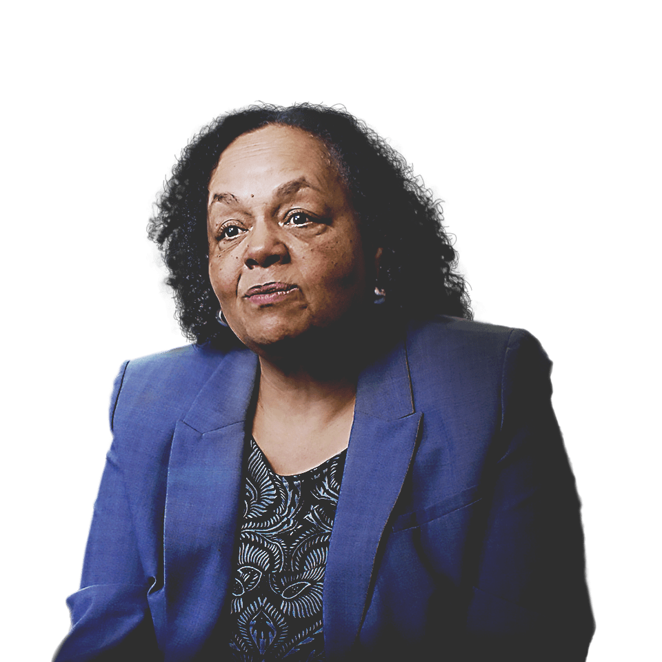 Darlene Flynn, Oakland executive director of race and equity, wearing a blue blazer sitting in front of a cityscape