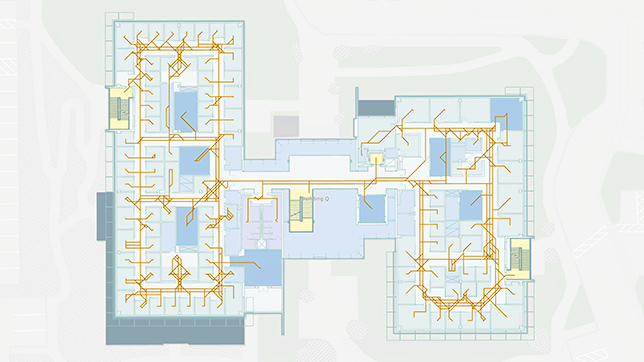 Indoor map of an office building with orange routing networks showing possible navigation routes,Indoor map of an office building with orange routing networks showing possible navigation routes