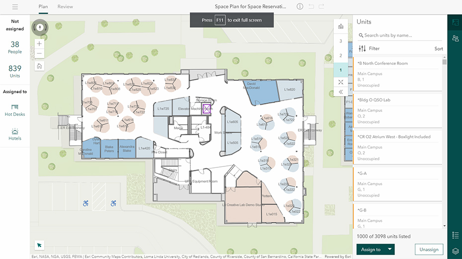 A 2D indoor map with offices highlighted in blue and gray squares in ArcGIS Indoors Spaces with a white box with text ,A 2D indoor map with offices highlighted in blue and gray squares in ArcGIS Indoors Spaces with a white box with text 