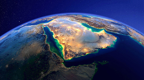 A graphic of a satellite image of a section of the Earth brightly lit for nighttime with a deep blue night sky in the background