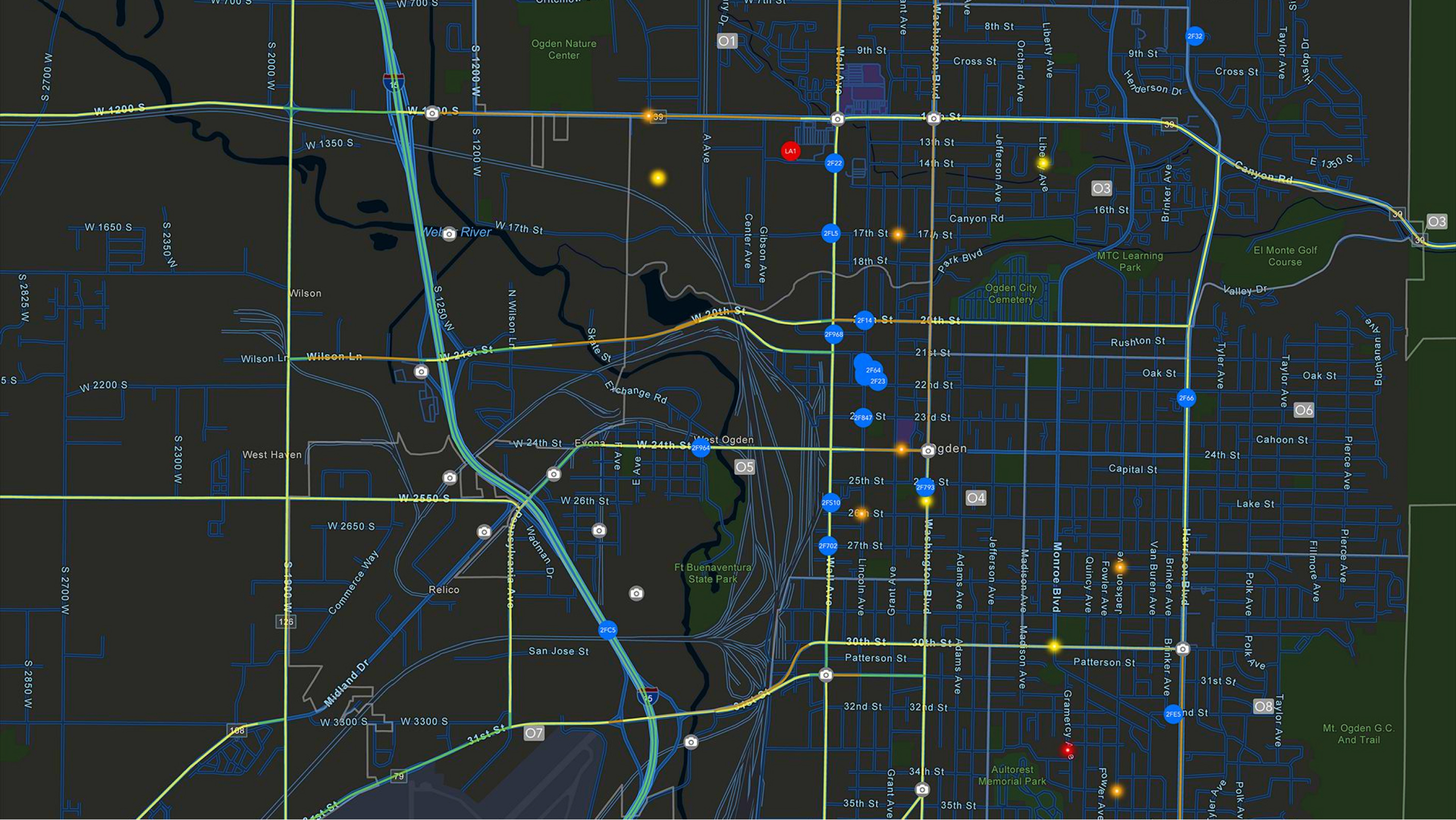 A black colored map showing streets, rivers, and highway routes highlighted in yellow with several scattered solid circles 
