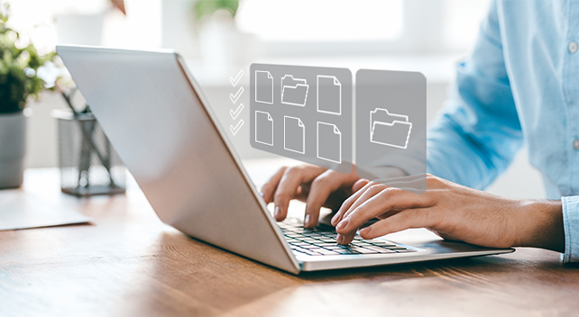 A person using a laptop on a sunlit wooden desktop, overlaid with several file icons