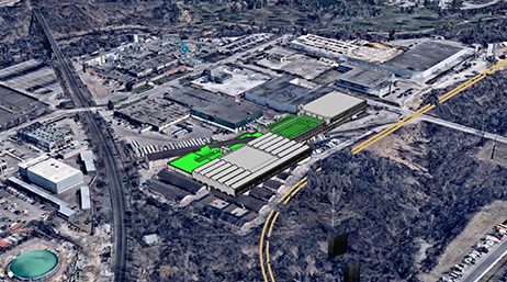 A 3D building model superimposed on an aerial photo of an existing structure complex