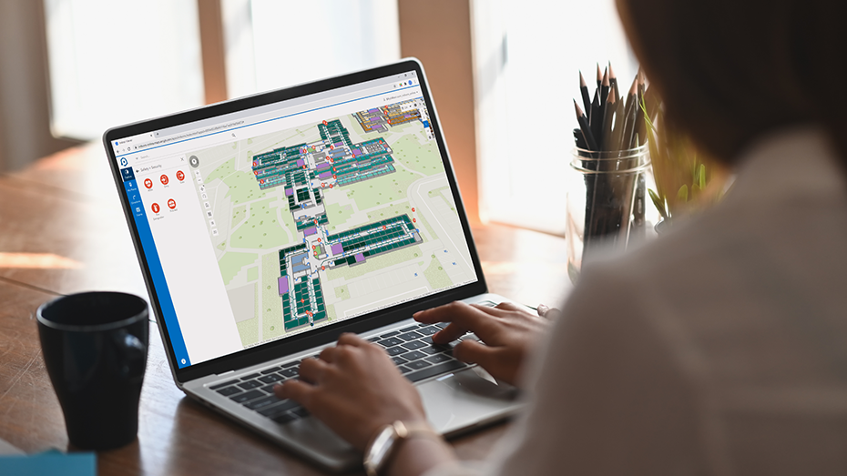 Person working from home on a laptop using ArcGIS Indoors to review space usage on an indoor map