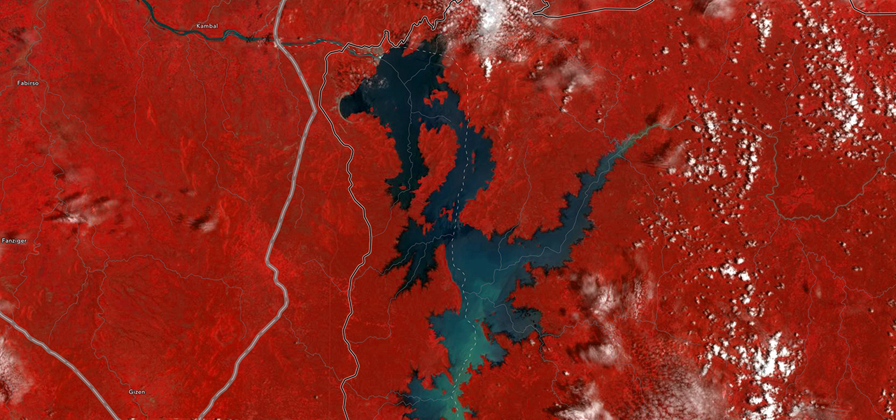 A map with land shaded in red surrounding a blue body of water