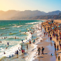 A busy beach in Santa Monica, California, as seen from the pier