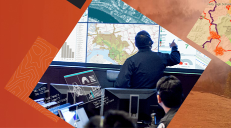 An emergency response team looking at maps on large televisions
