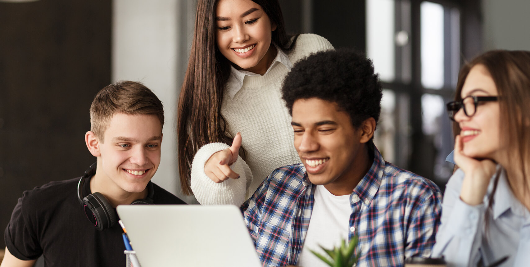 Four students looking at the monitor