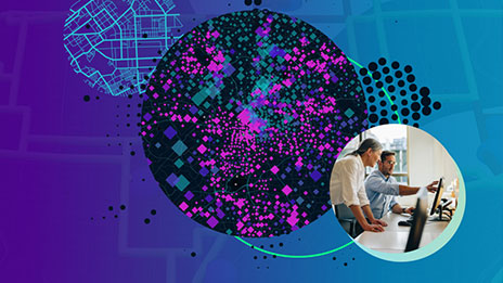 Abstract image with colorful stylized maps within round borders and an image of two people in collared shirts discussing a monitor display in a brightly lit modern office
