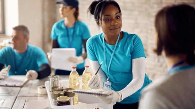 People wearing blue shirts and white gloves