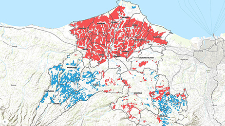 Map with land in beige and the ocean in blue with several regions shaded in blue and red