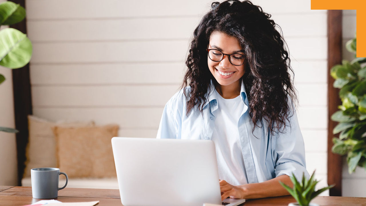 A person sitting at a table using a laptop